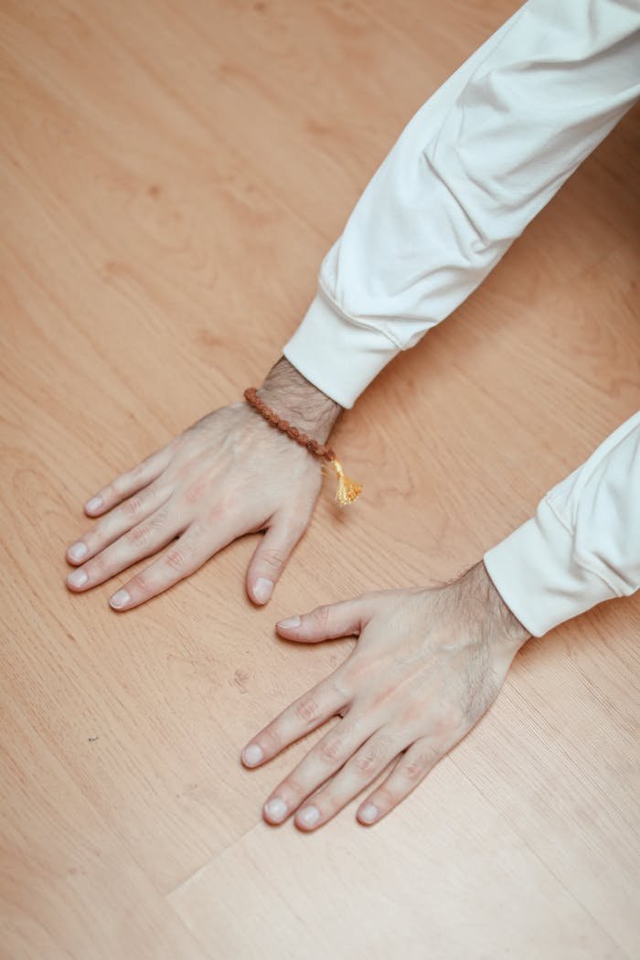 Person in White Long Sleeve Shirt Wearing a Mala Beaded Bracelet